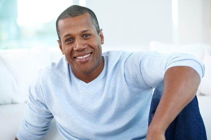 Testosterone Therapy Smiling man likely feeling benefits of testosterone therapy.